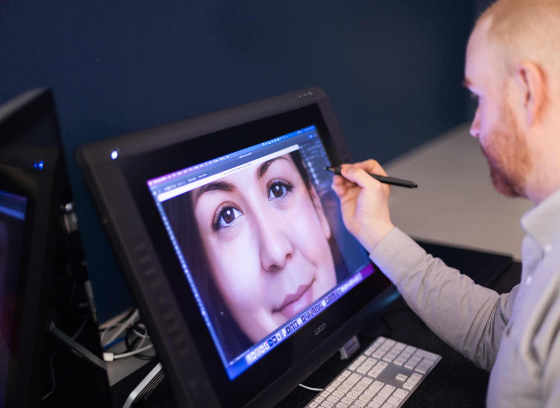 man works on computer screen creating age progression